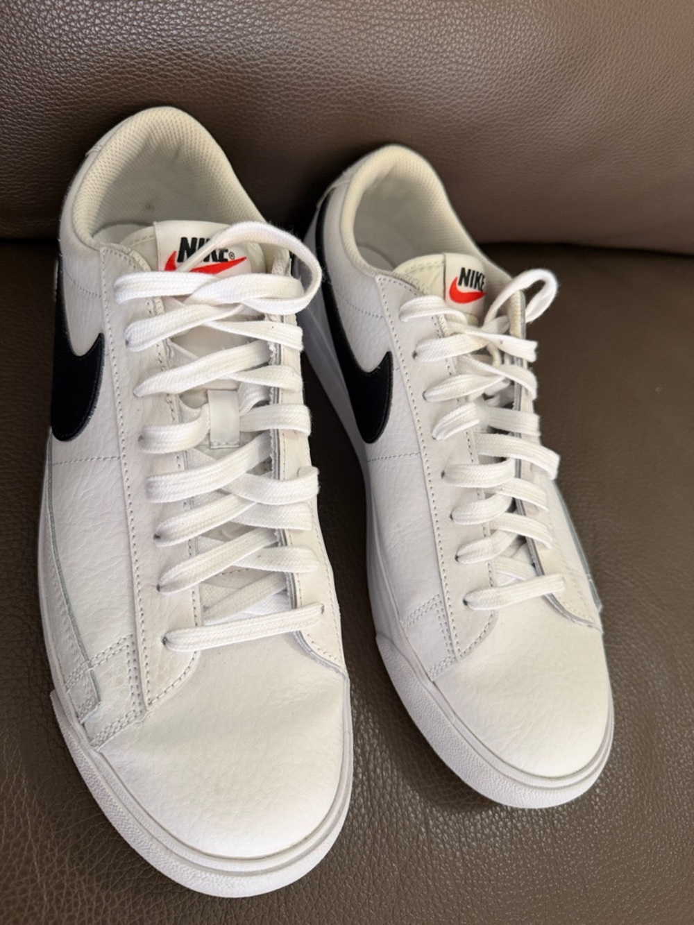 Nike Men’s White Sneakers with Black Swoosh and Red Tongue Logo